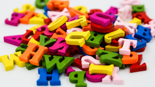 istock Randomly scattered colorful wooden letters on a white background. 925259850