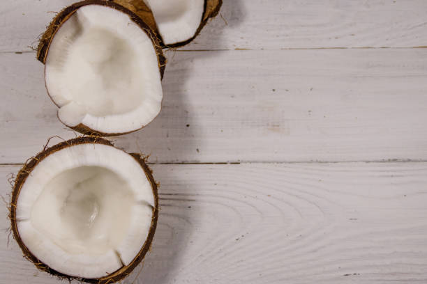 istock Fresh ripe coconut on white wooden table 925260790