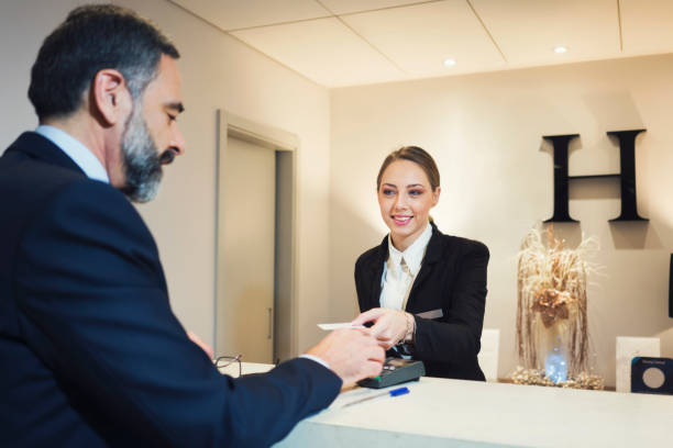 istock Business man at reception desk 925261106