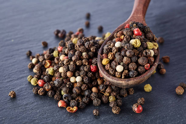 istock black pepper peas in a spoon on a stone background 925261482
