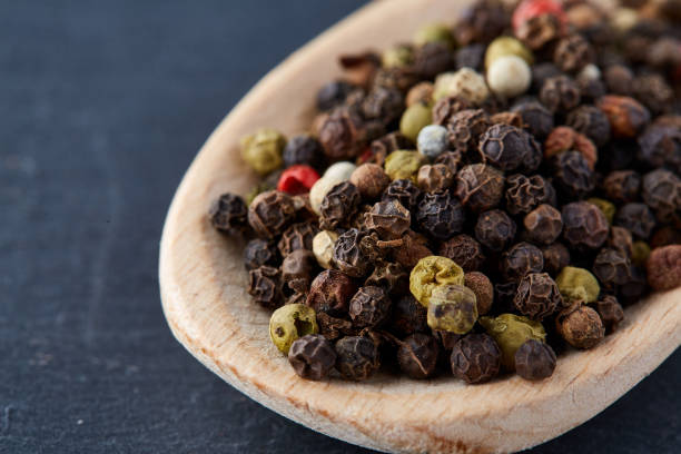 istock black pepper peas in a spoon on a stone background 925264596