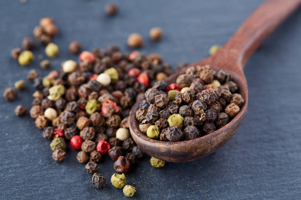 istock black pepper peas in a spoon on a stone background 925267028