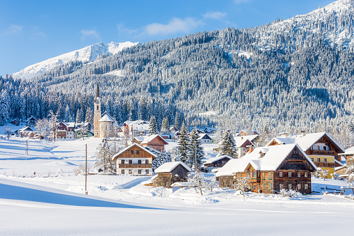 Beautiful panoramic view of historic Gosau mountain village on a scenic cold sunny day with blue sky and clouds in winter, Salzkammergut, Upper Austria region, Austria