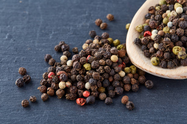 istock black pepper peas in a spoon on a stone background 925269032