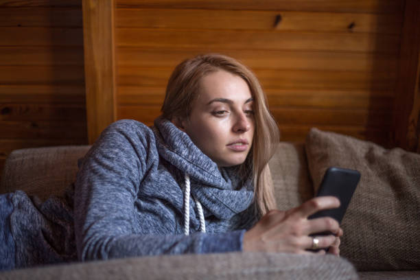 istock Woman using mobile phone in home 925269272