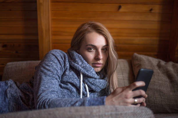 istock Woman using mobile phone in home 925269288