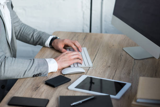 istock cropped image of businessman typing on keyboard in office 925269542