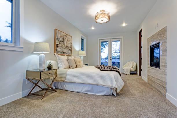 istock New luxury custom built home with white master bedroom. 925273624