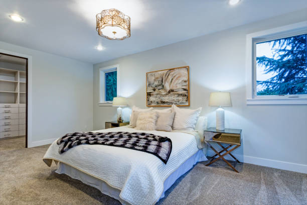 istock New luxury custom built home with white master bedroom. 925276192