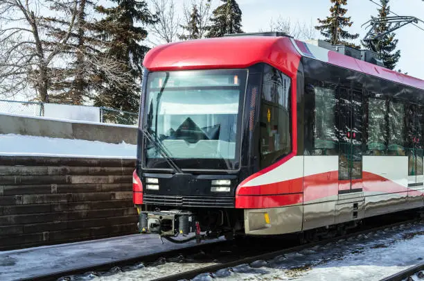 Light Rail Train on Tracks covered in Snow on a Sunny Winter Day