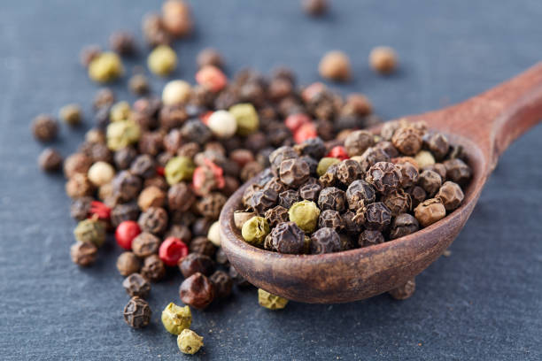 istock black pepper peas in a spoon on a stone background 925277576
