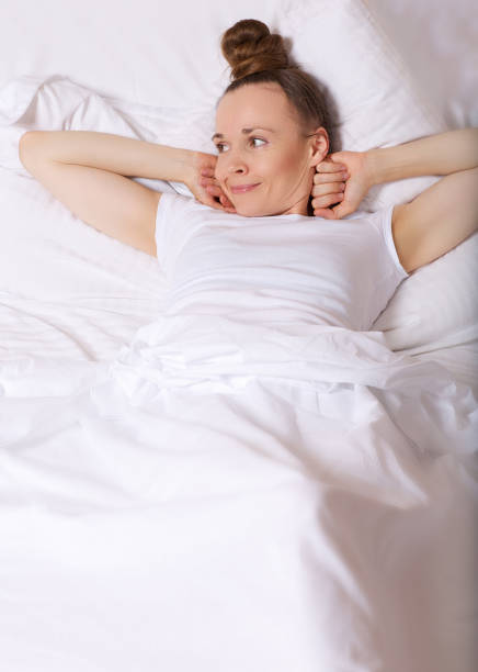 istock Young lady between 30 and 40 years old stays in her bed. 925280534