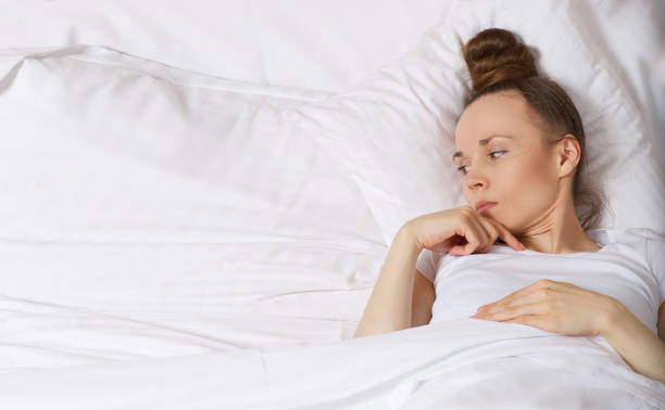 istock Young upset lady between 30 and 40 years old stays in her bed. 925280540