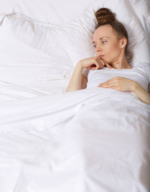istock Young upset lady between 30 and 40 years old stays in her bed. 925280604