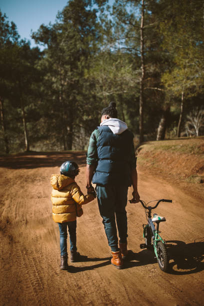 istock Young father and son with bicycle hiking in the forest 925280990
