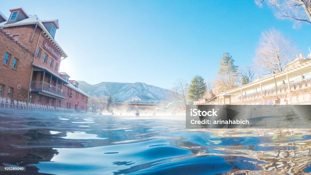 Swimming in outdoor hot springs pool Swimming in outdoor hot springs pool in the Winter. Glenwood Springs Stock Photo