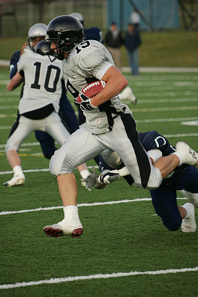 istock Football Running Back Carries Ball for Big Gain 92528708