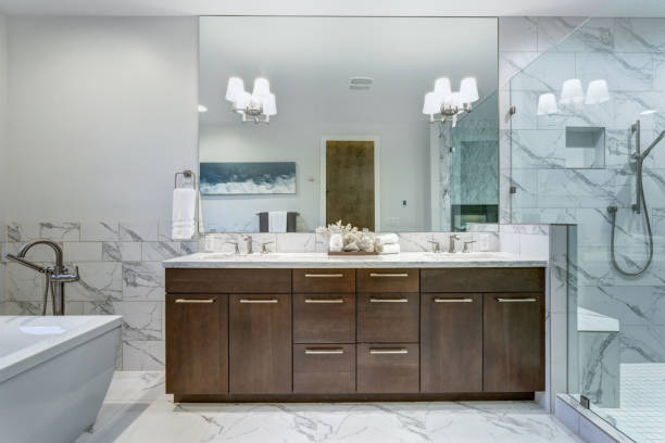 Incredible master bathroom with Carrara marble tile surround. stock photo