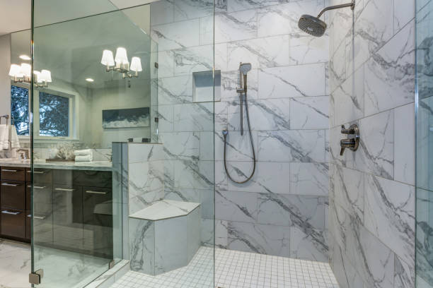 Incredible master bathroom with Carrara marble tile surround. stock photo