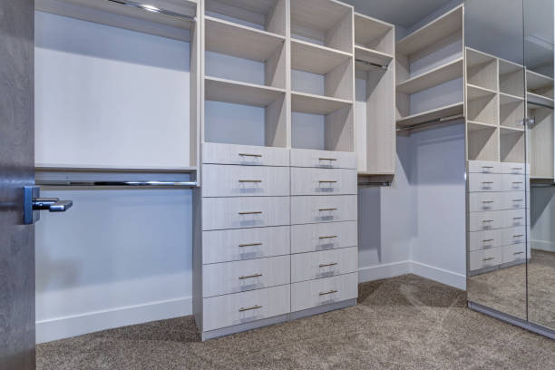 istock Large walk-in closet with white shelves, drawers 925288572