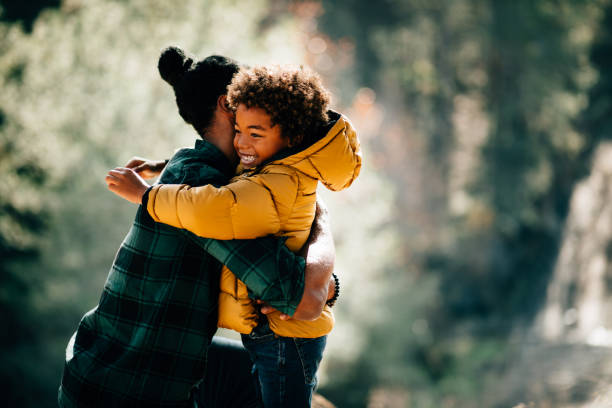 istock Loving father hugging son in nature park 925289628