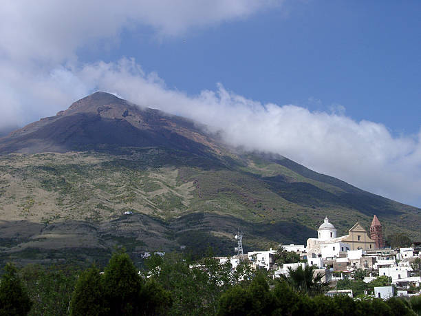 istock steaming stromboli volcano and town buildings, Sicily, Italy 92529540