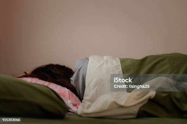 Young Woman Is Sleeping From The Back In Bed Stock Photo - Download Image Now - Bed - Furniture, Women, One Woman Only