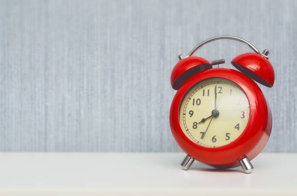 istock Red alarm clock on the table background. 925303226