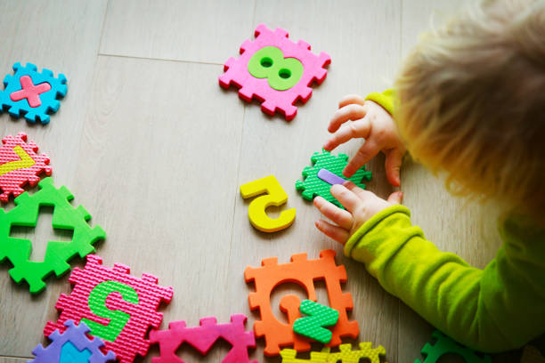 istock little girl playing with puzzle, early education 925303250