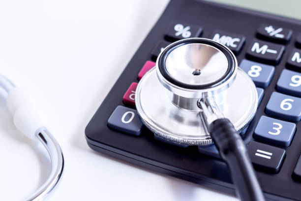 istock Stethoscope and calculator isolated on white table background. 925303910