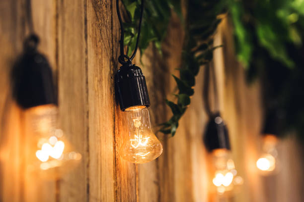 istock Wedding background of boards, decorated with light bulbs and flowers 925307576