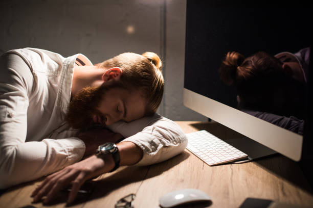 istock businessman sleeping on table at workplace in evening 925307736