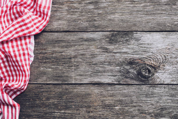 istock Kitchen plaid textile on old rustic wood. Food menu background 925309004
