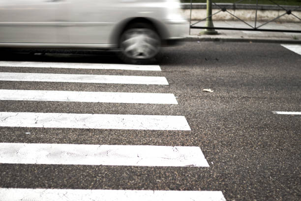 istock Pedestrian crossing with unfocused car in the background 925310330