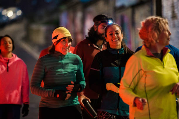 istock Group Of Friends Running Together At Night 925310450