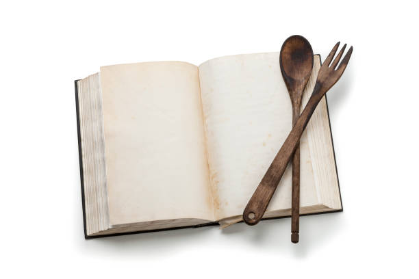 istock Open cookbook isolated on white background 925315002