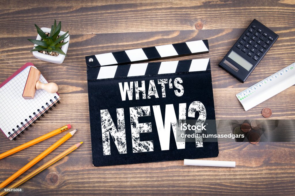 What's New? Movie clapper on a wooden desk New Stock Photo