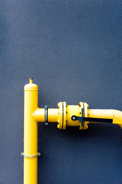 istock Yellow gas pipe and blue wall 925315370