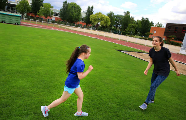 istock Girls have fun on the stadium 925316412
