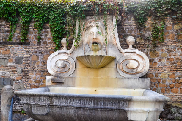 istock Drinking fountain with image of head in Rome 925319536