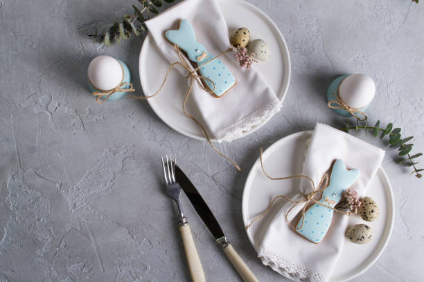 istock Homemade easter cookies in the shape of  a  funny  rabbit  on white plate. Easter  festive table setting. Holiday decorations. 925323480
