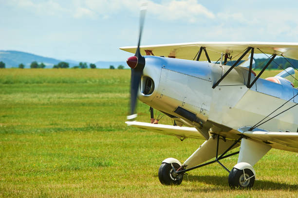 istock Old biplane is taking off from the grass airstrip 925323918