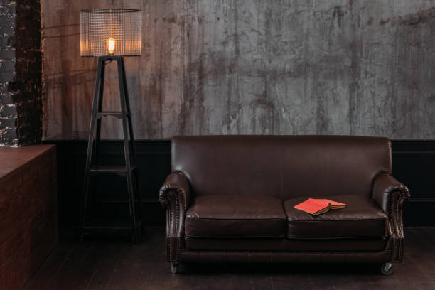 istock interior of stylish room in loft design with book lying on couch 925324372