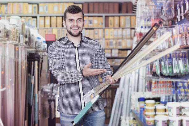 istock Positive guy choosing on best molding in store 925327564