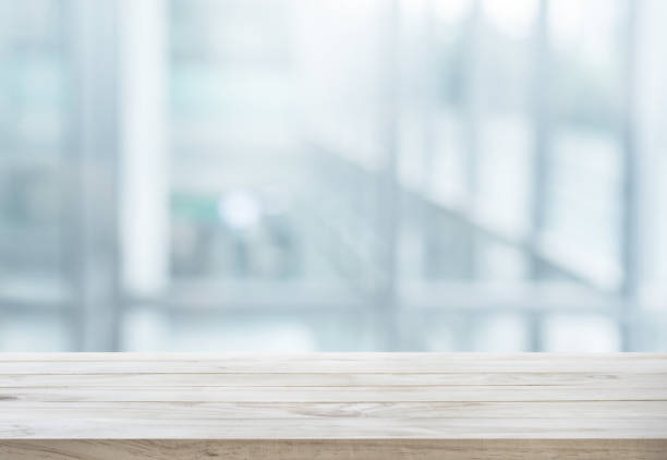 istock Wood table top on white abstract background form office building. 925331128