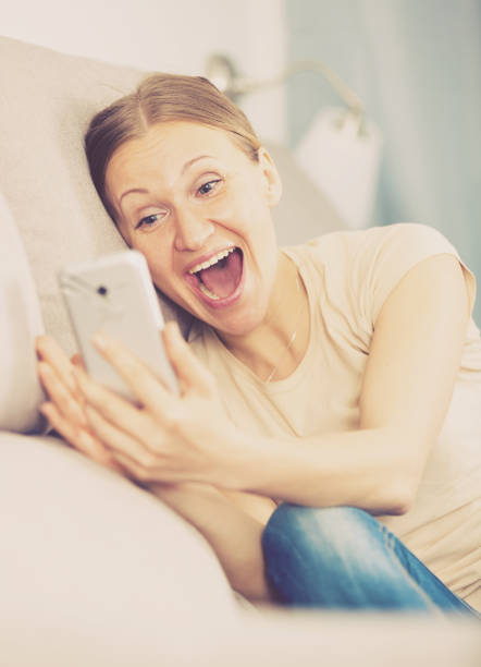 istock Woman with phone on sofa 925331498