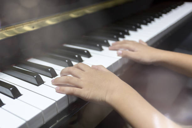 istock hands of kid playing piano 925333058