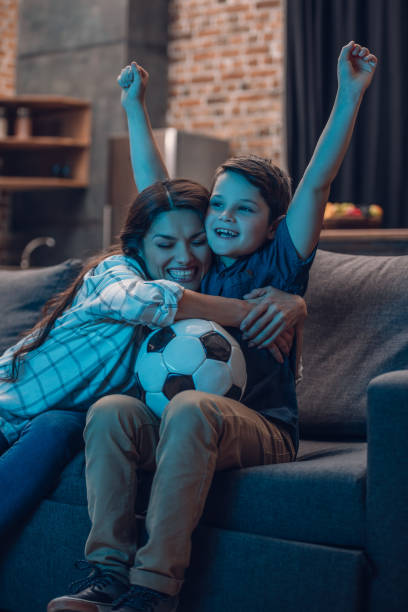 istock Hugging mother and son watching soccer 925333112