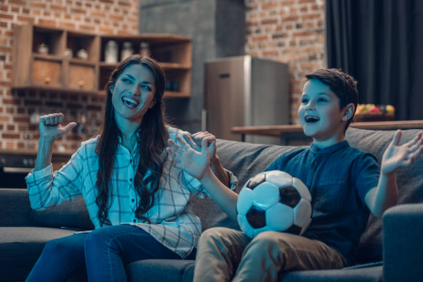 istock Excited mother and son watching soccer 925337196