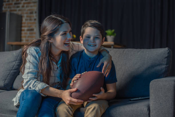 istock Hugging mother and son watching rugby 925337376